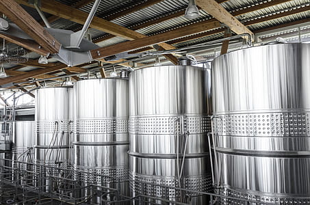 several silver tanks inside factory thumbnail