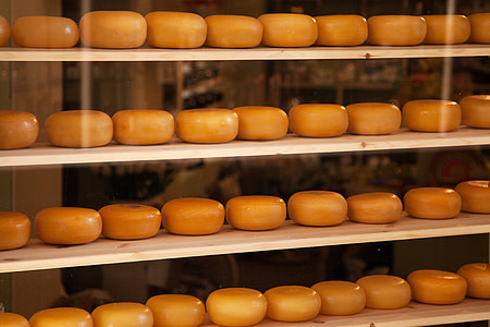 cheeses on brown wooden rack inside room thumbnail