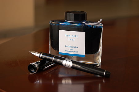 black pen with ink bottle on focus photography thumbnail