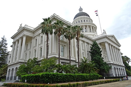 white building under cloudy day sky thumbnail