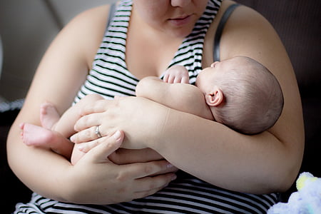photo of baby carried by woman thumbnail