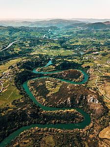 bird's eye view landscape photo of mountain near river thumbnail