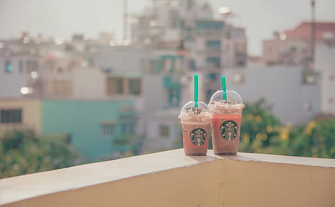 Close-Up Photography of Two Starbucks Disposable Cups thumbnail