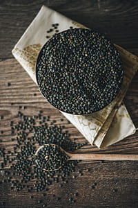 black pepper on container beside wooden spoon thumbnail