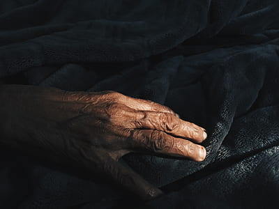person holding at the black textile thumbnail