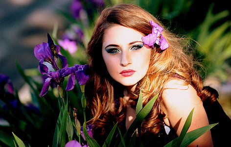 woman beside purple petaled flowers thumbnail