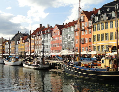 boat on river near colorful buildings during daytime thumbnail