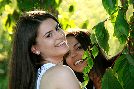 two woman taking selfies thumbnail