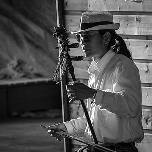 grayscale photography of man standing near wall thumbnail