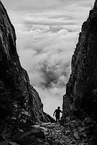 Silhouette of Man Walking Between Two Cliff thumbnail