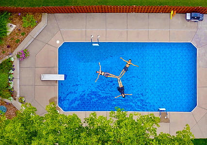 three women floating link feet in pool at daytime thumbnail