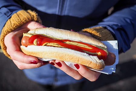person holding hotdog sandwicj thumbnail