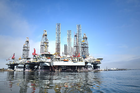 selective focus photography of gasoline building on body of water thumbnail