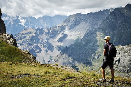 man standing near mountain at daytime thumbnail