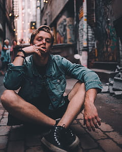 man sitting on brick pavement thumbnail