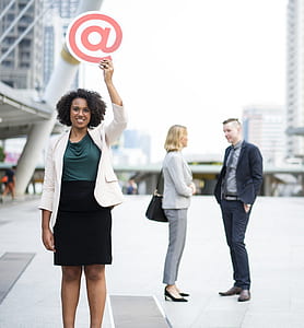 woman in gray blazer holding red letter a logo thumbnail