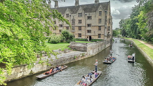people in boat near concrete house thumbnail