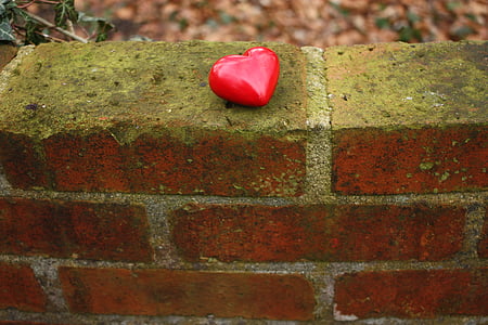 red heart figurine on brown brick thumbnail