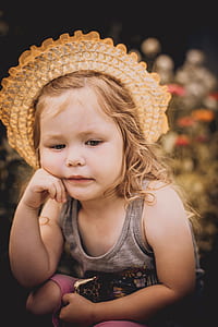 closeup photo of girl resting face on her right hand thumbnail