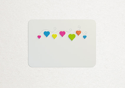 seven assorted color hearts on white paper thumbnail