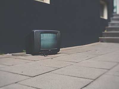 black CRT TV on brown brick thumbnail