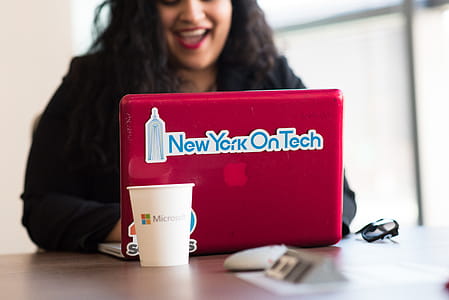 Selective Focus Phot of Woman Typing on Red Macbook thumbnail