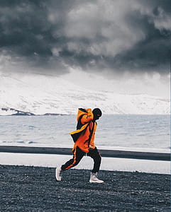 man carrying bag white walking near lake thumbnail