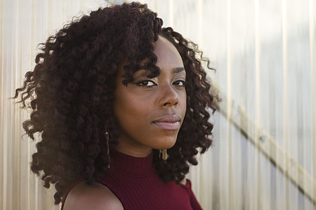 woman wearing maroon sleeveless collared top thumbnail