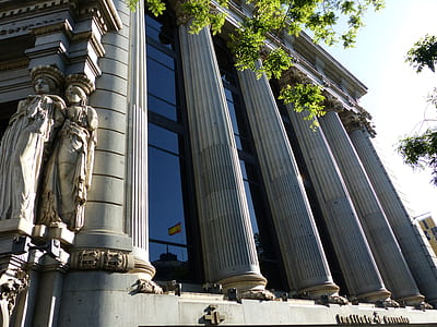 grey stone building surrounded by trees thumbnail
