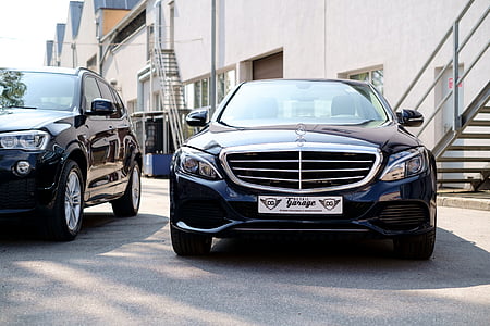 blue Mercedes-Benz vehicle parked near building thumbnail