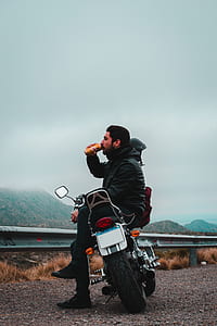 man seats on cruiser motorcycle thumbnail