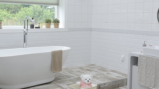 white ceramic tub with stainless steel faucet during day time thumbnail