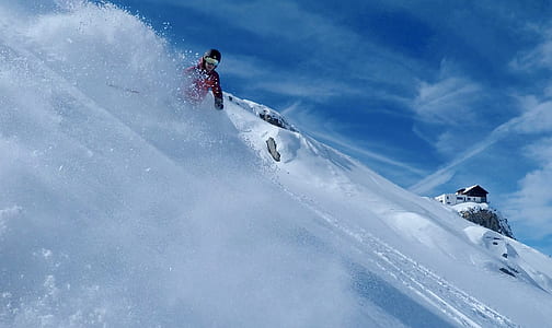 man riding on snowboard on snow field at daytime thumbnail