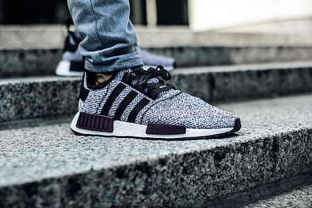 person showing pair of gray-and-black adidas running shoes thumbnail