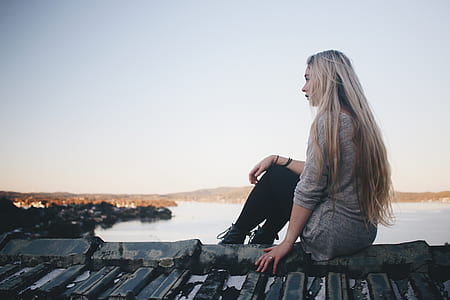 woman wearing gray top sitting on roof thumbnail