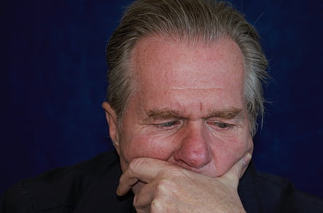 man in black shirt putting his left hand on his face thumbnail