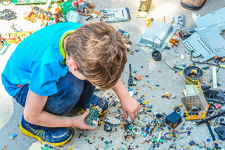 boy wearing blue shirt and blue denim jeans playing on the ground thumbnail