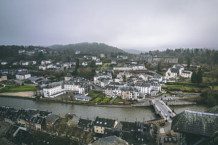 town with river under cloudy day sky thumbnail