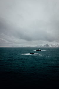 body of water near mountain thumbnail
