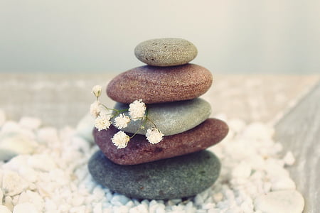 rock balancing on white textile thumbnail
