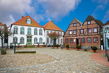 houses under cloudy sky during daytime thumbnail