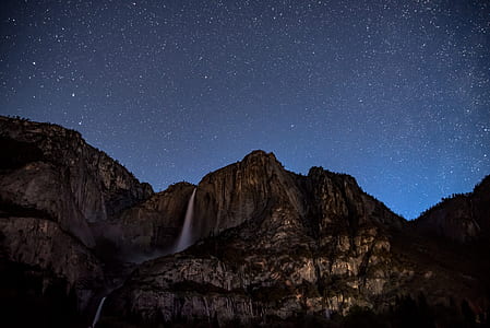 shallow photography of mountain under night sky thumbnail