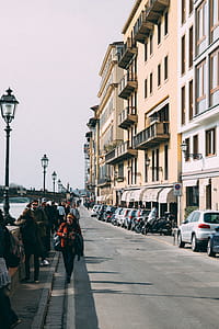People Walking Along Pavement Near Building thumbnail