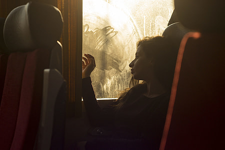 woman in black long-sleeved top near window thumbnail