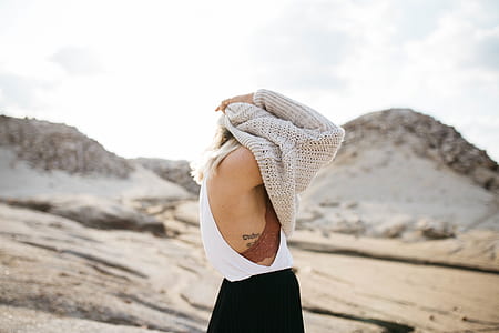 Women Taking Off knitted sweater thumbnail