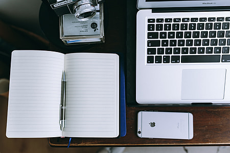 Elegant workspace with Macbook, iPhone, business cards and notebooks thumbnail