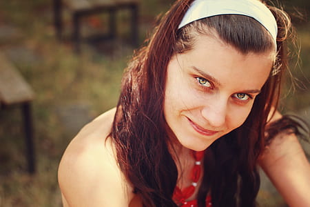 woman wearing white headband and red sleeveless top thumbnail