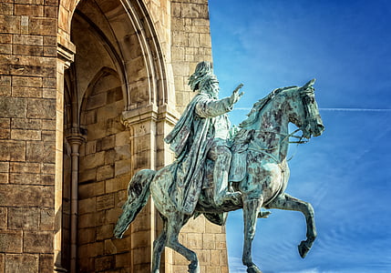 man riding on a horse statue during daytime thumbnail