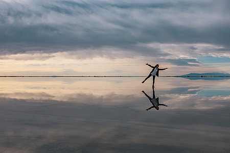 person standing under white clouds thumbnail