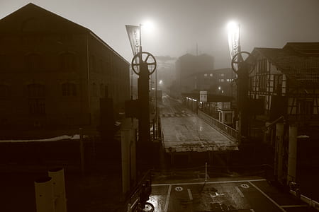 grayscale photography of broken bridge between buildings thumbnail